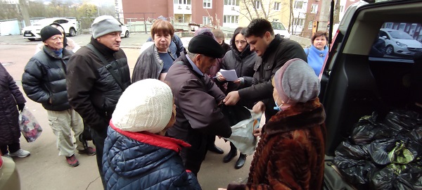 Служитель місії роздає пакунки із продуктами незрячим та слабозорим, Київ